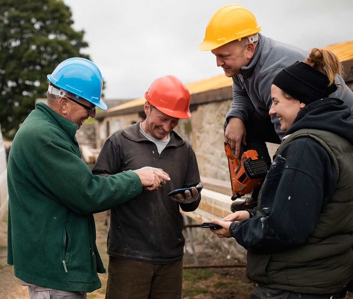 Group of workers outside looking at device
